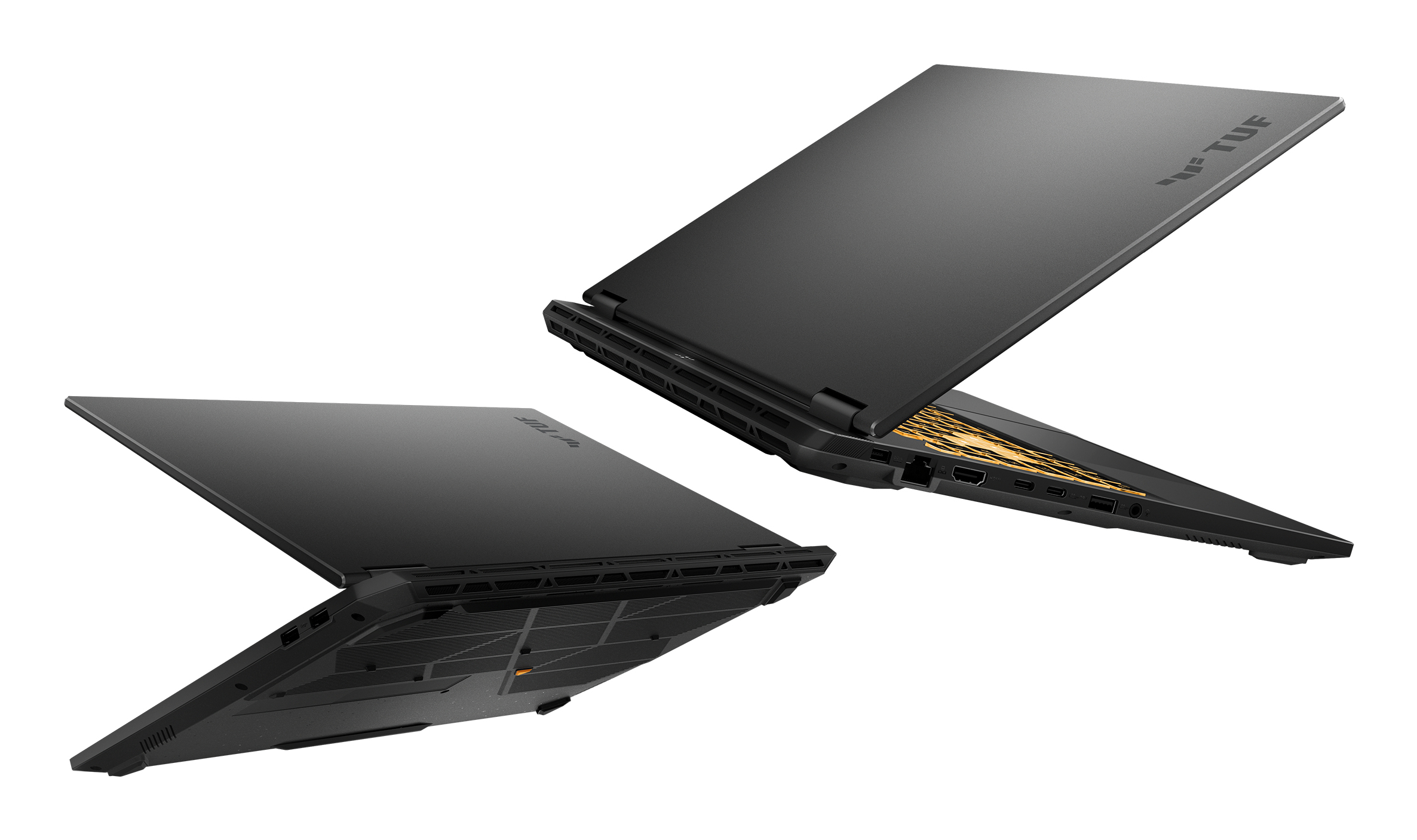 Due laptop neri sono esposti. Uno è aperto, rivelando un interno dorato. Entrambi mostrano il logo TUF.