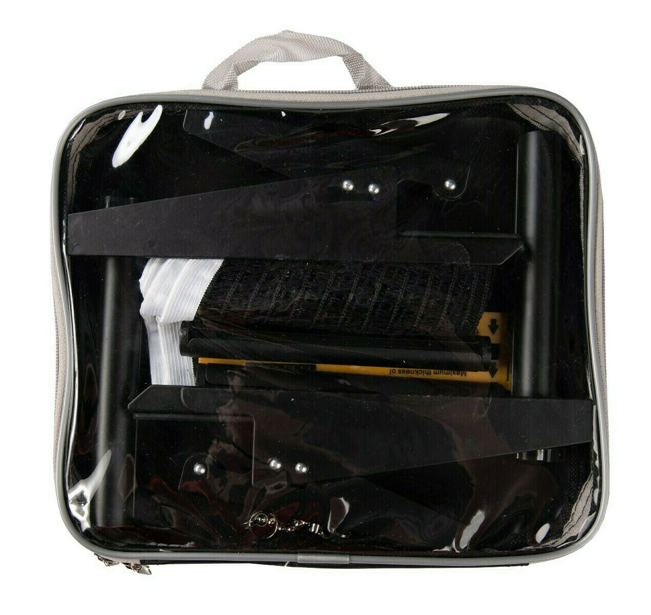 A clear bag contains black objects, a white mesh, and a yellow ruler. The bag has a gray handle and trim.