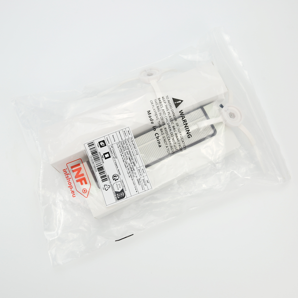 Biały filtr w przezroczystym plastikowym worku. Worek jest zamknięty białymi opaskami. Widoczny tekst i kod kreskowy.