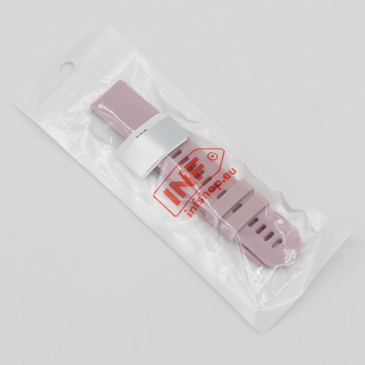 Ein rosafarbenes Uhrenarmband in einer durchsichtigen Plastiktüte. Die Tüte hat oben ein Loch. Das Armband hat ein Etikett.