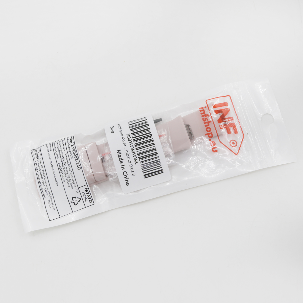 Różowy pasek do zegarka w przezroczystym plastikowym opakowaniu z kodem kreskowym i etykietami tekstowymi na białym tle.