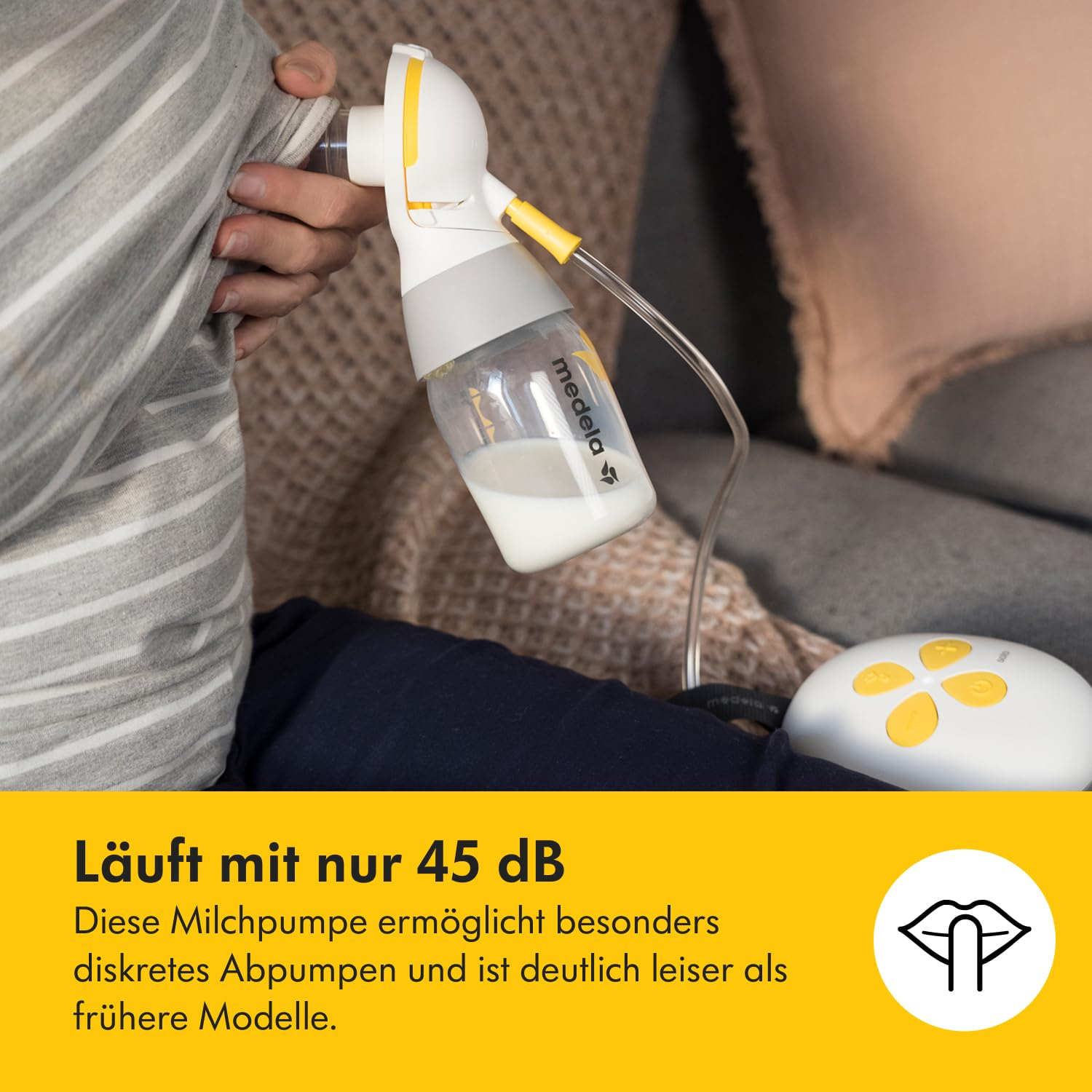 Eine Person benutzt eine weiße und gelbe Milchpumpe. Die Flasche enthält Milch. Der Text auf dem Bild besagt, dass sie mit 45 dB arbeitet.