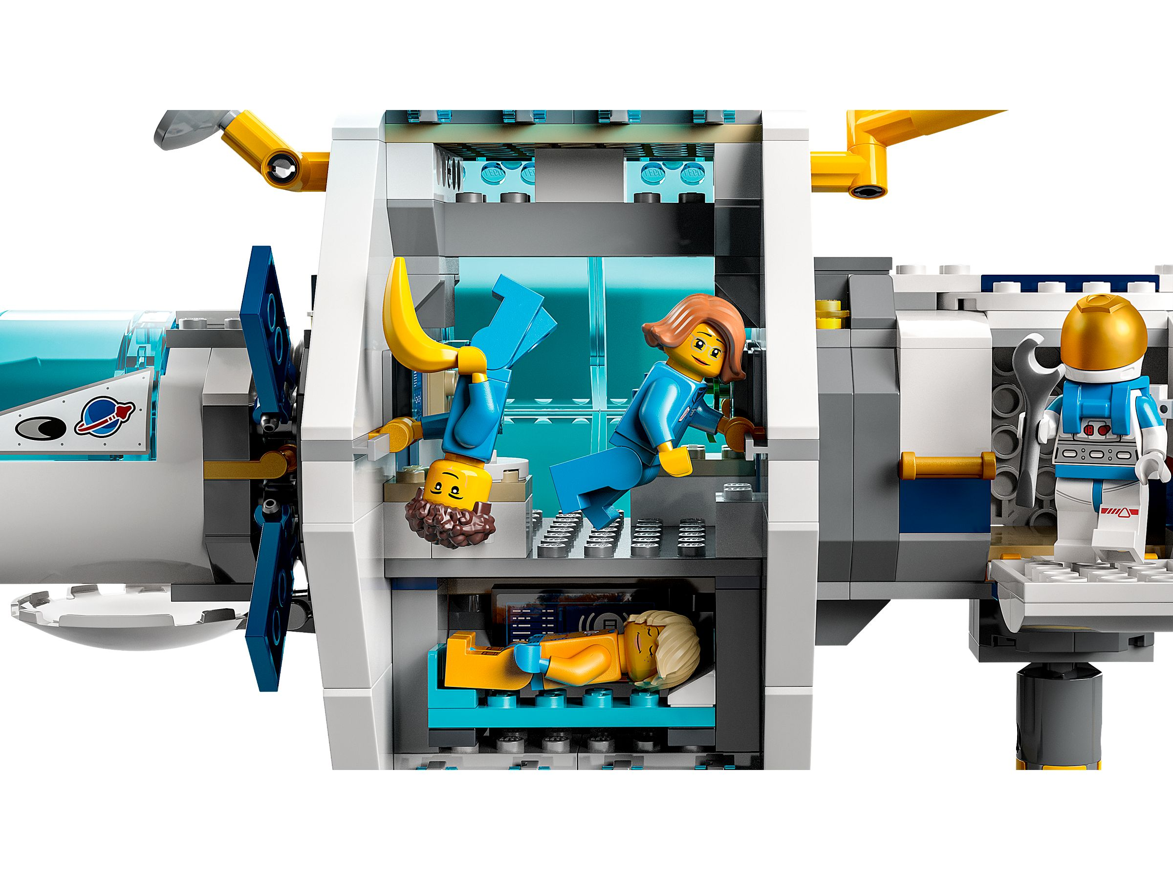 Lego-Set mit Astronauten in einem Raumschiff. Einer ist kopfüber. Ein anderer hält ein Werkzeug. Einer liegt.