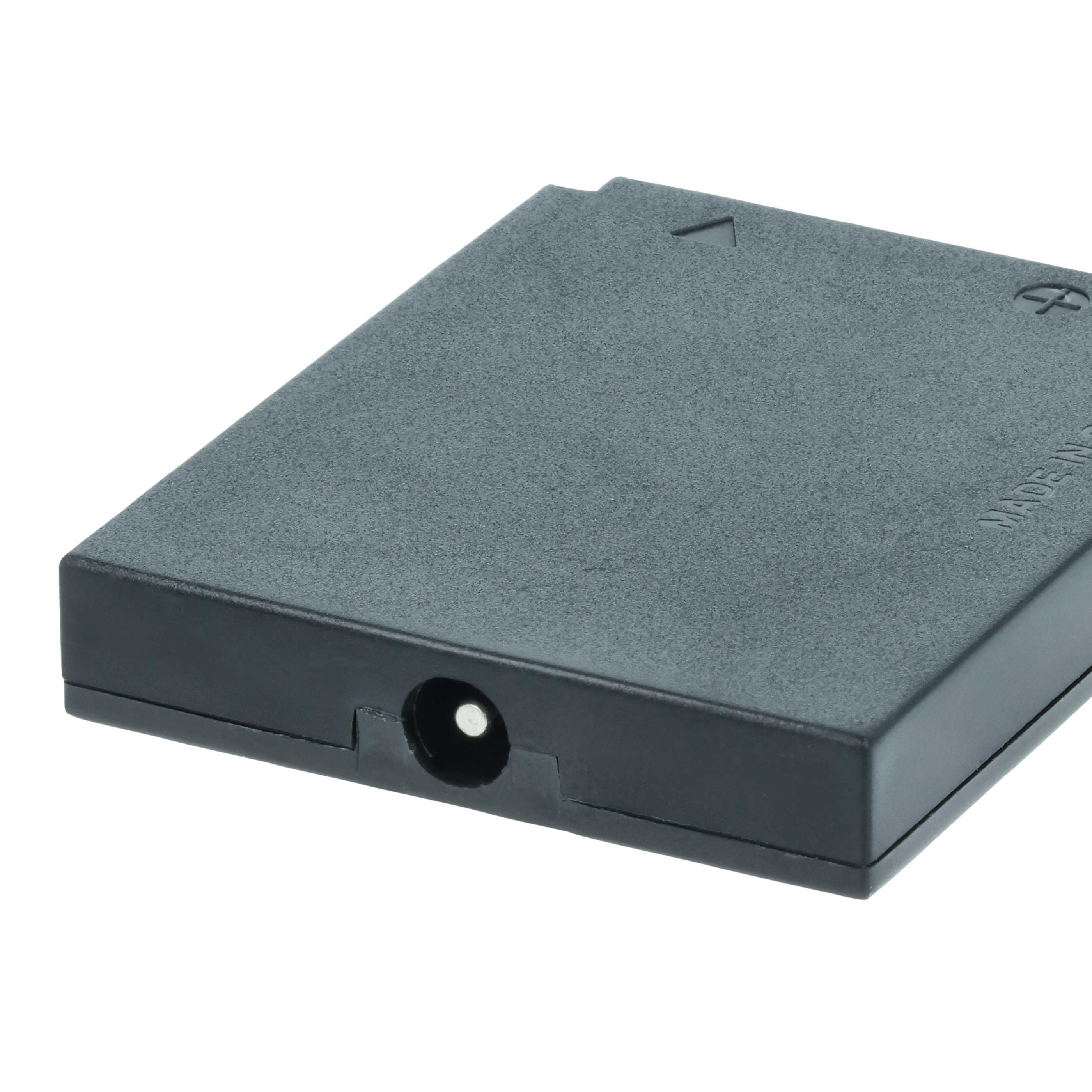 Eine dunkelgraue rechteckige Box mit einem runden Loch auf einer Seite. Sie hat einen Stromanschluss und einen weißen Hintergrund.