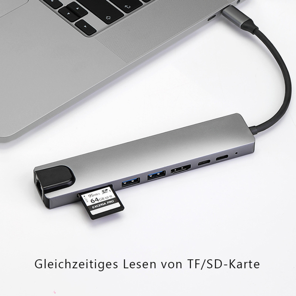 Grauer USB-Hub, verbunden mit Laptop. Speicherkarte eingesetzt. Text unten: 'Gleichzeitiges Lesen von TF/SD-Karte'.