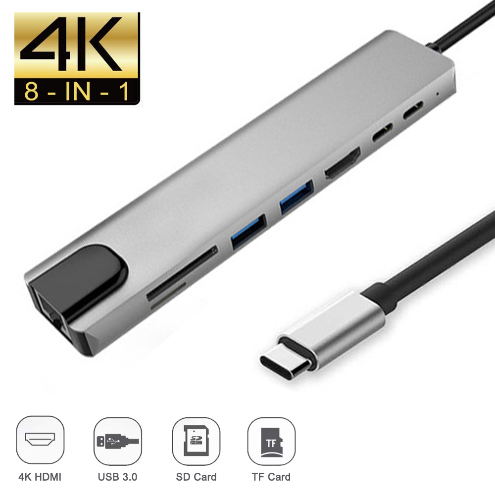Ein silberner 8-in-1-USB-Hub mit mehreren Anschlüssen, einschließlich HDMI, USB 3.0 und Kartenlesern, mit angeschlossenem USB-C-Kabel.