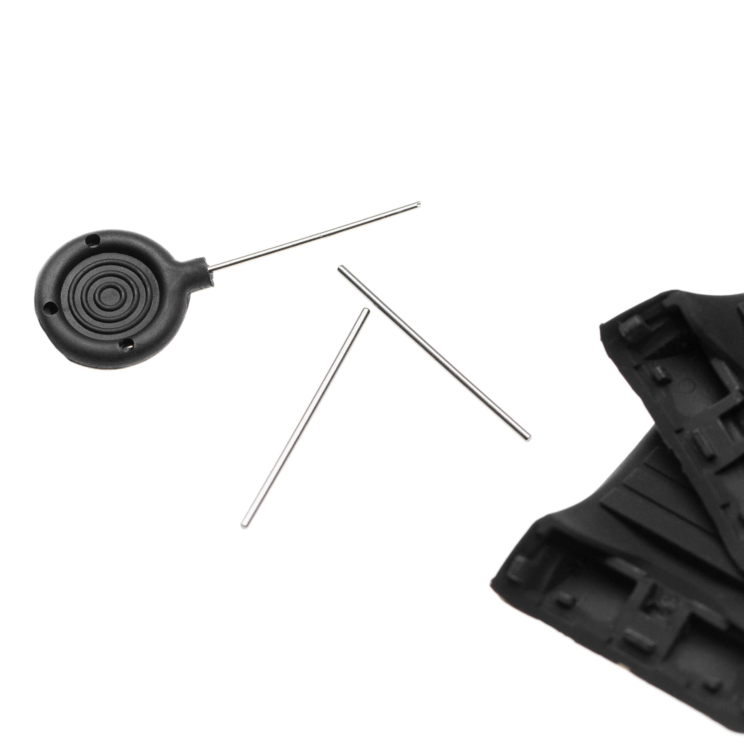 Schwarzes Werkzeug mit Stift und zwei separaten Stiften auf weißem Hintergrund, zusammen mit schwarzen Kunststoffteilen.