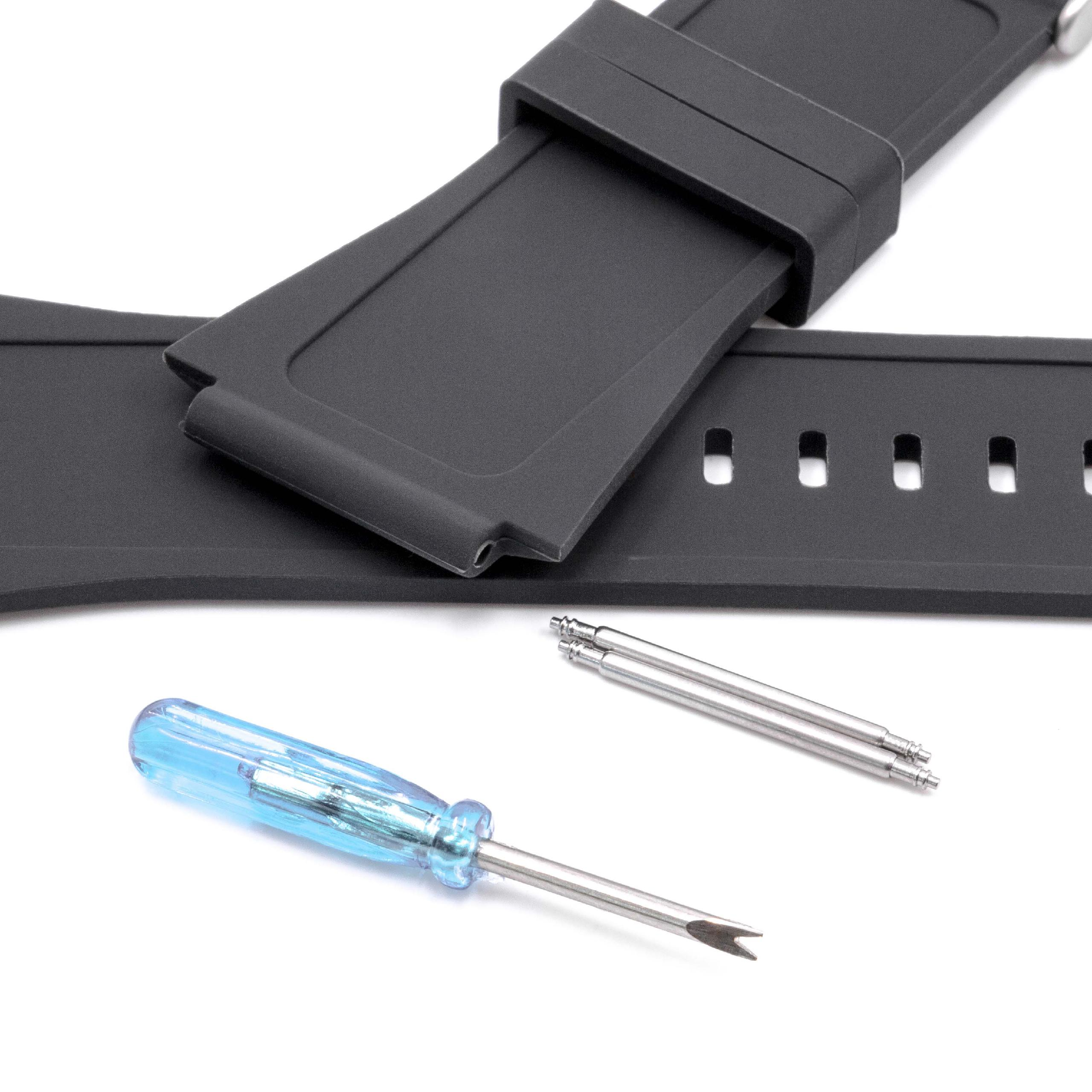 Schwarzes Armband mit Werkzeug und Stiften auf Weiß. Das Armband liegt über dem Werkzeug. Der Werkzeuggriff ist blau.