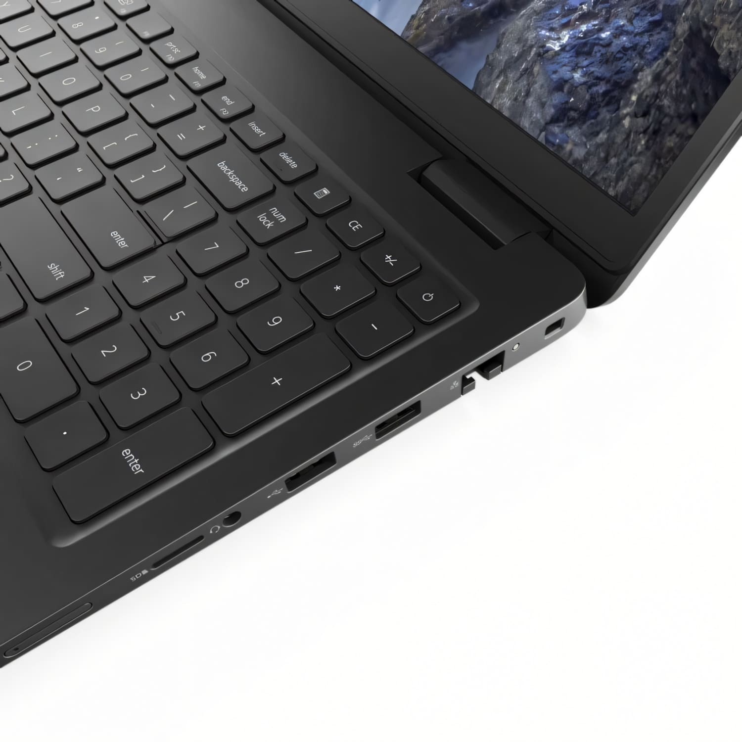 Primer plano de una computadora portátil negra, mostrando el teclado y la pantalla que muestra una imagen de montaña.