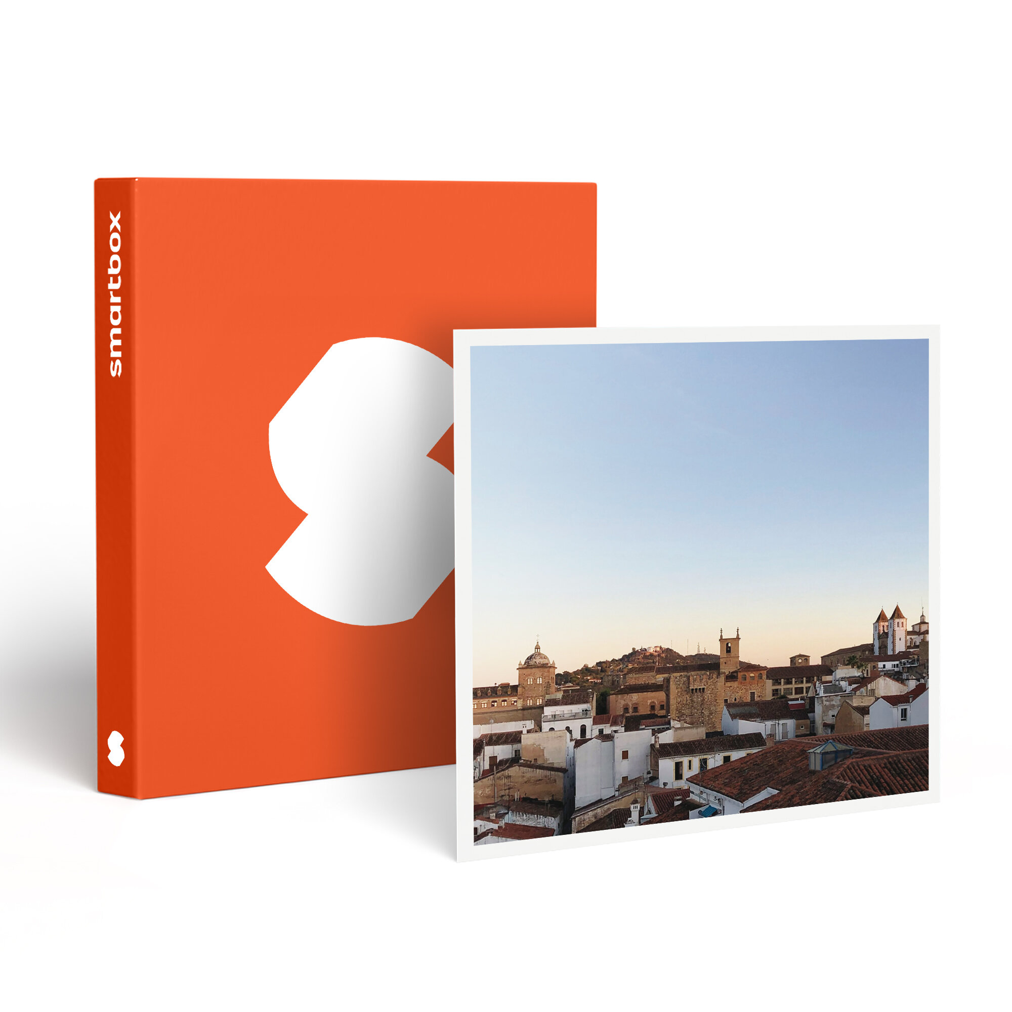 Una caja naranja con una forma blanca está junto a una foto enmarcada de un paisaje urbano con tejados rojos.