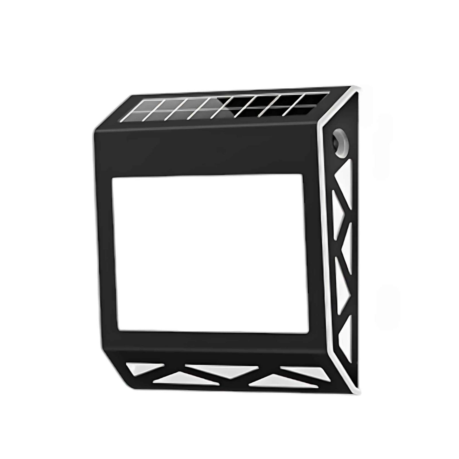 Eine schwarz-weiße solarbetriebene LED-Leuchte. Es hat eine rechteckige Form mit einem weißen Innenrahmen.