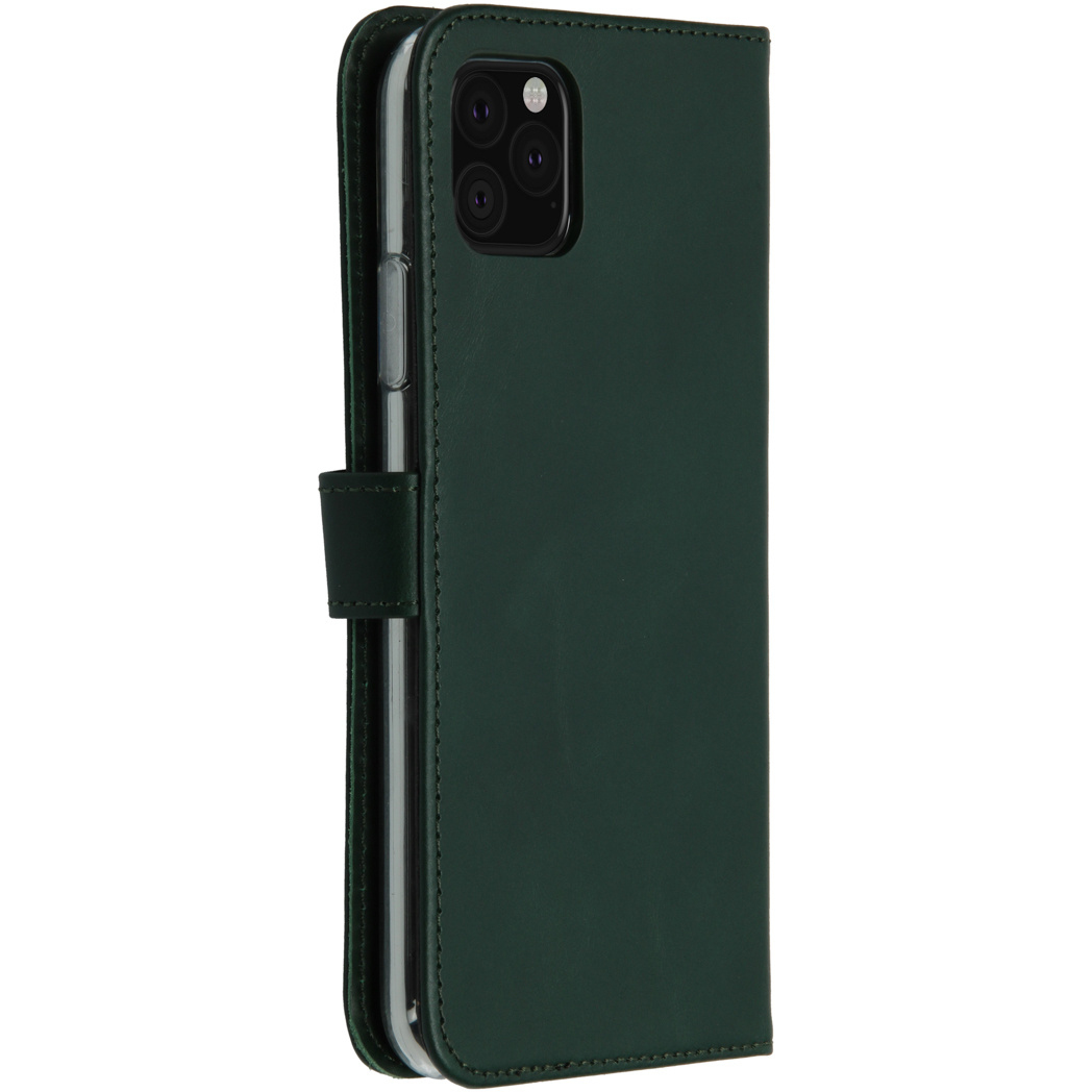 Un étui de téléphone vert foncé avec un téléphone à l'intérieur. L'étui est fermé par une petite sangle. Le téléphone a trois caméras.