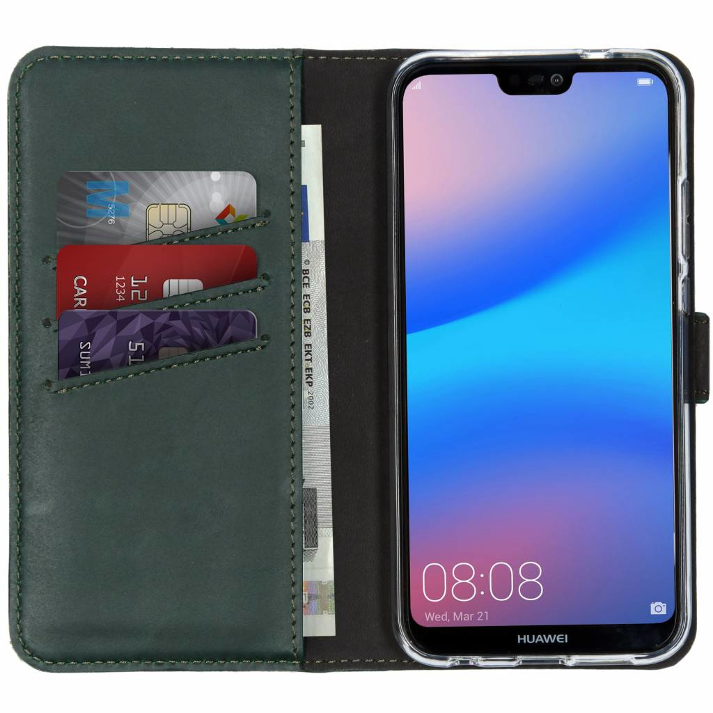 A phone in a green wallet with credit cards and money. The phone shows a blue screen with the time.