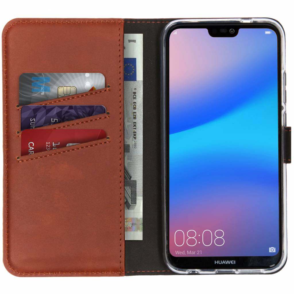 A phone in a brown wallet case with credit cards and a euro bill visible. The phone's screen shows the time.