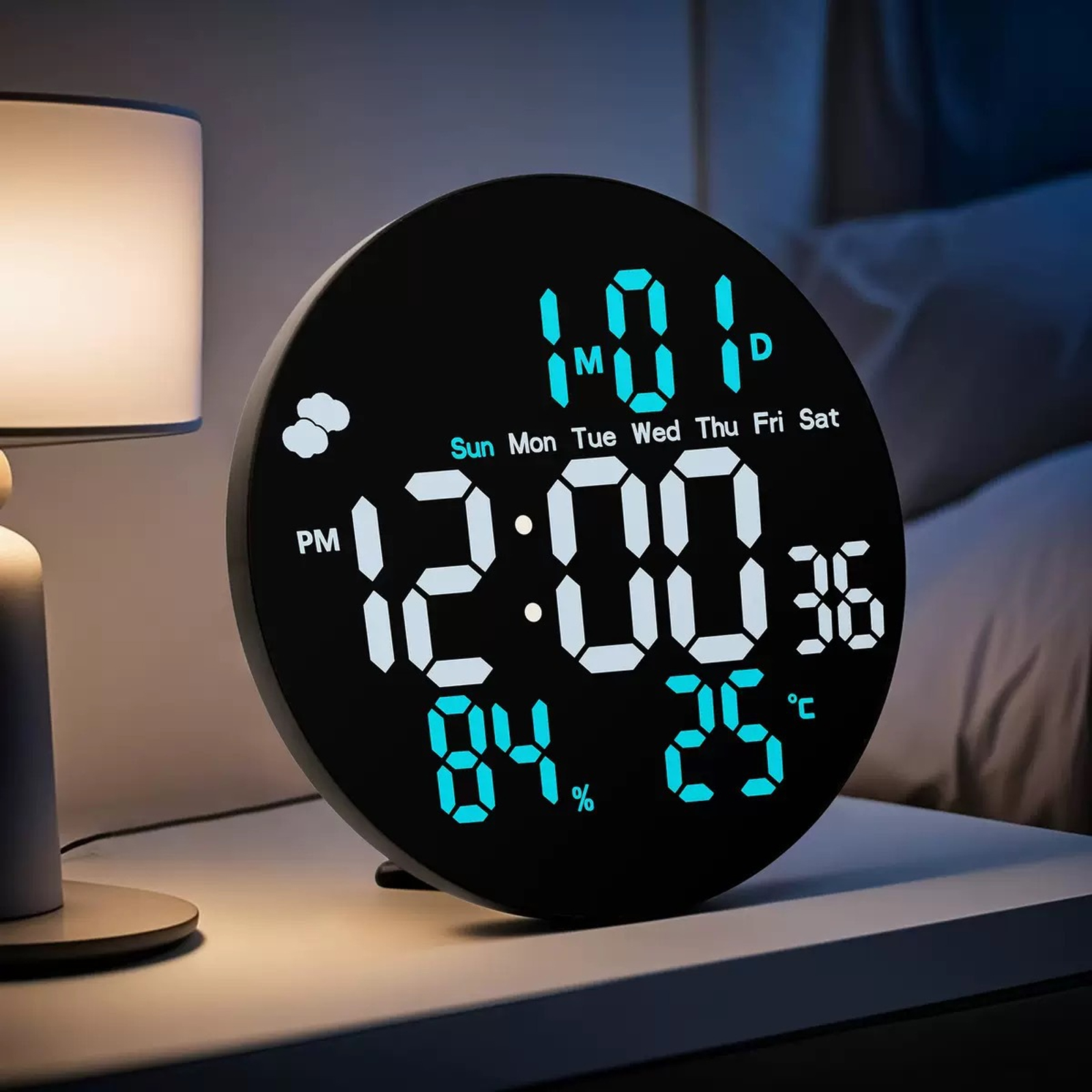 Un orologio digitale mostra l'ora, la data e le informazioni meteo. È su un comodino accanto a una lampada. Lo sfondo è un letto.