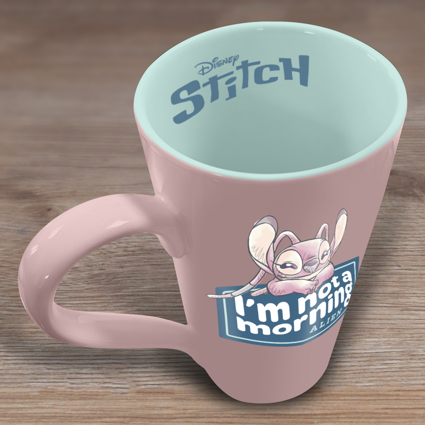 Eine rosa Tasse mit Stitch-Design, die Innenseite ist mintgrün. Sie trägt den Text "I'm not a morning alien".