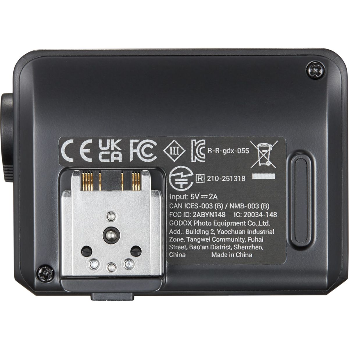 Black rectangular device with certification marks, a silver connector, and a label with technical specifications.