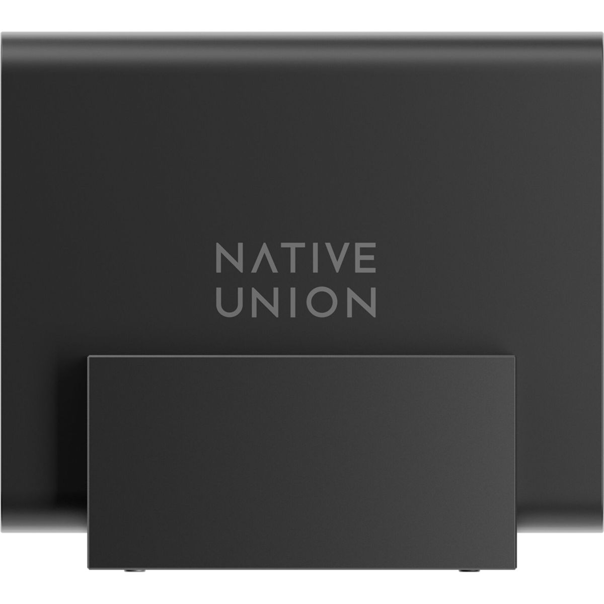 Un support Native Union gris foncé. Le nom de la marque est imprimé en gris clair. Un support rectangulaire soutient le corps principal.