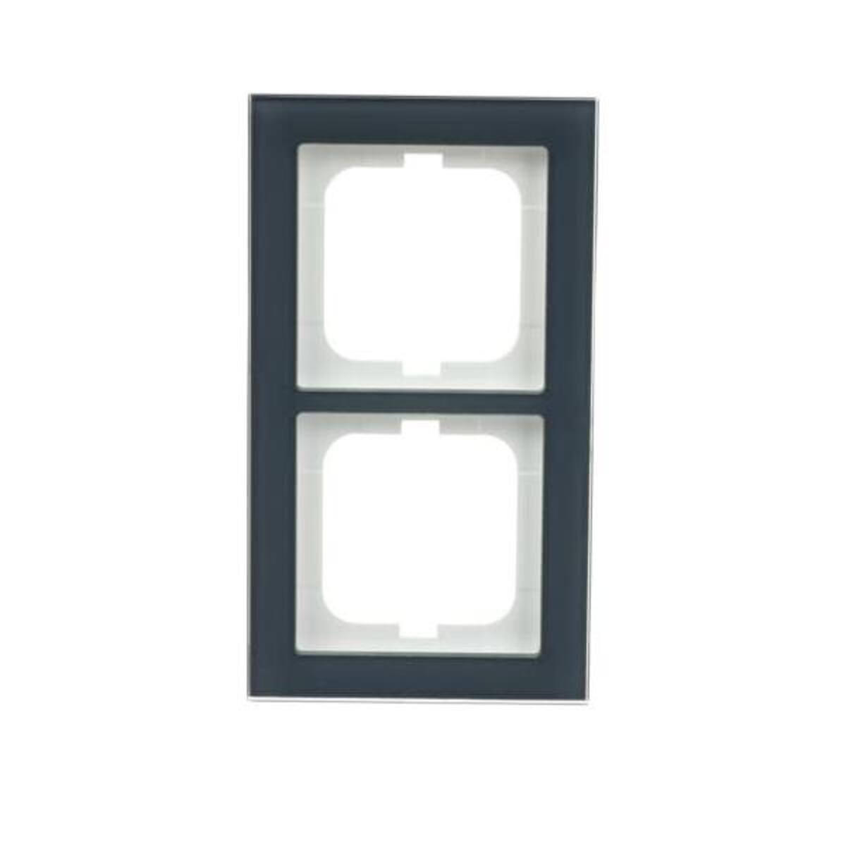 Una copertura per prese elettriche grigio scuro con due aperture quadrate su sfondo bianco. La cornice ha un bordo grigio scuro.