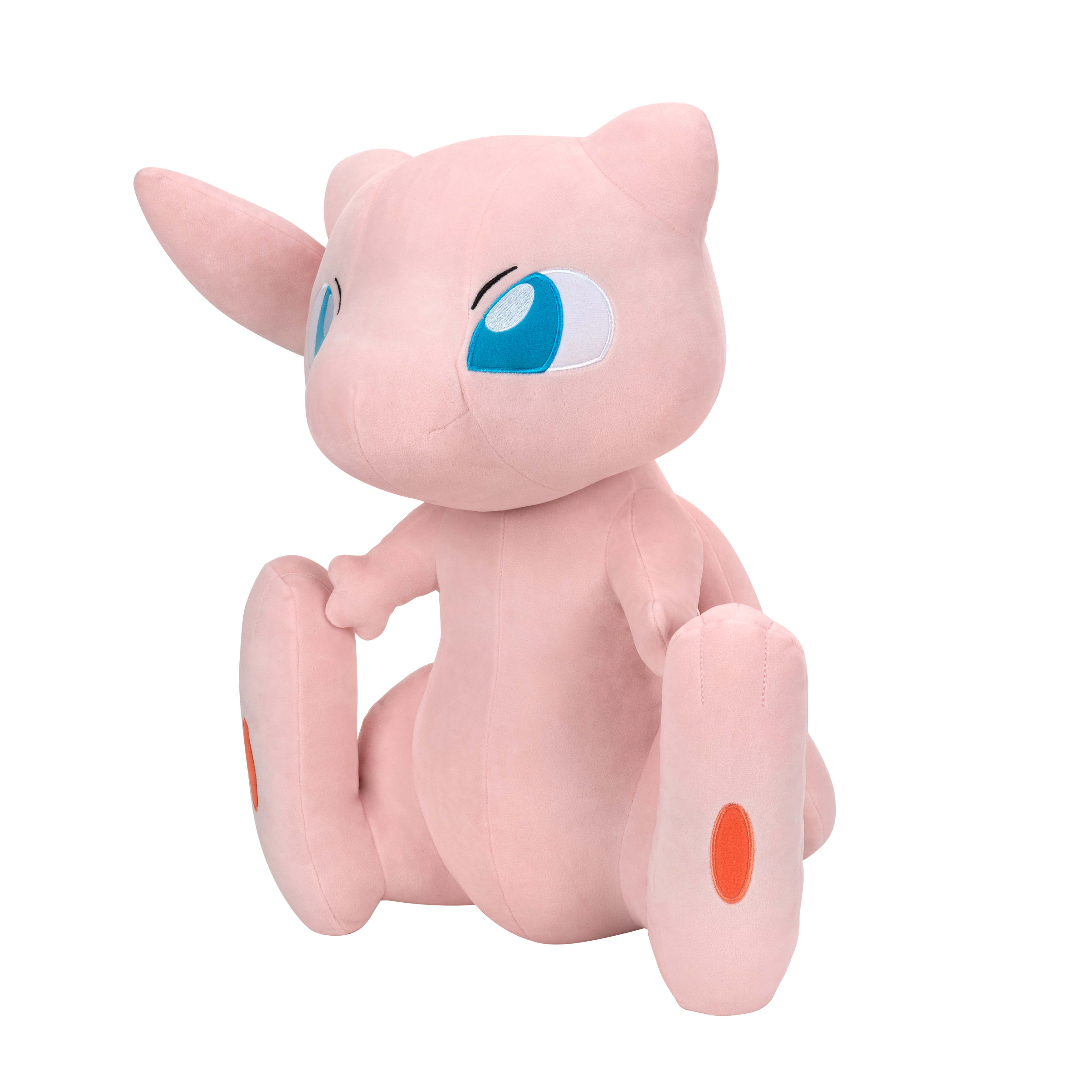 Ein rosa Mew-Plüschtier mit großen blauen Augen. Es sitzt mit ausgestreckten Beinen und hat einen orangefarbenen Fleck am Fuß.