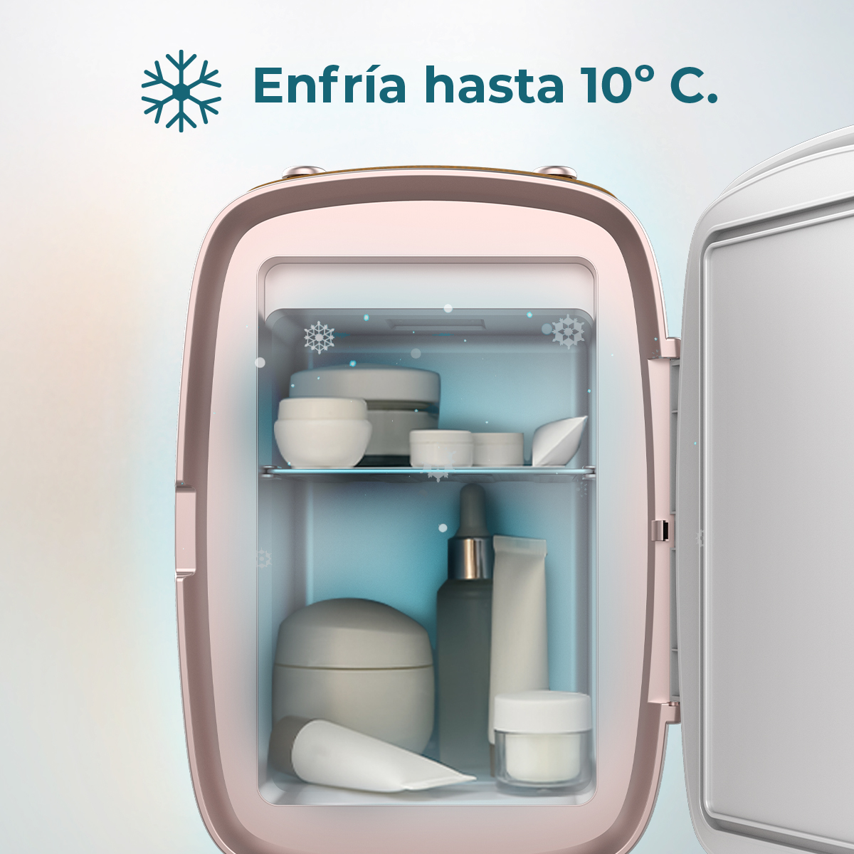 Un piccolo frigorifero rosa aperto con prodotti per la cura della pelle all'interno. Il testo sopra recita 'Enfría hasta 10° C.' con un'icona a fiocco di neve.