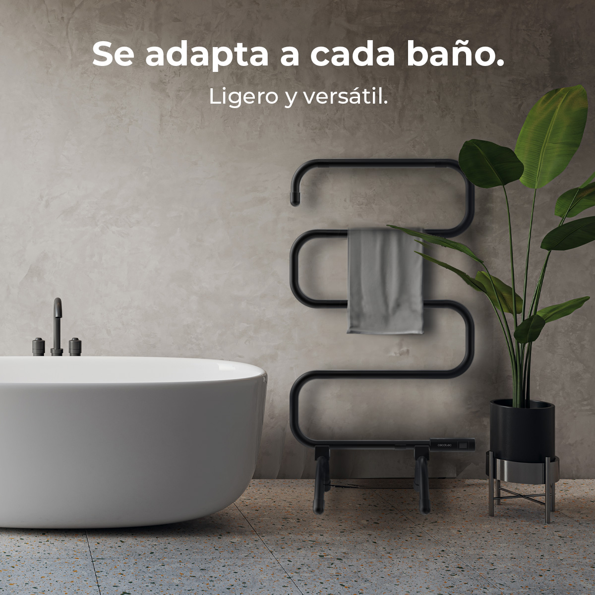 Bagno con vasca bianca, portasciugamani nero e pianta. Il muro è grigio e il pavimento ha un motivo maculato.