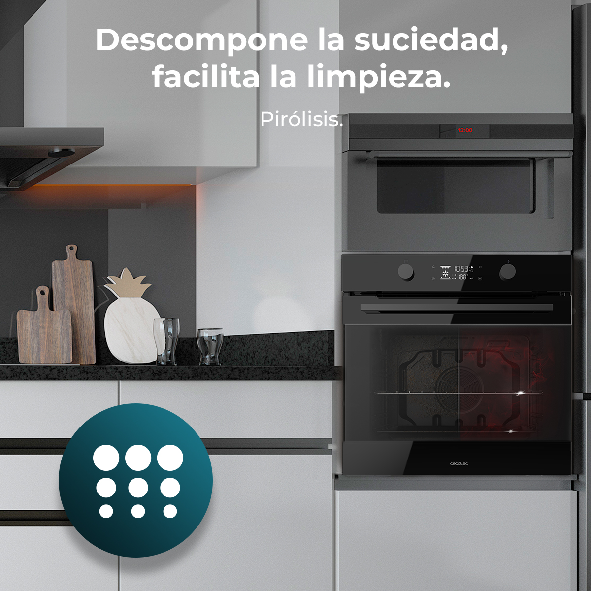 Cocina moderna con horno y microondas. Texto: 'Descompone la suciedad, facilita la limpieza'. Se ven tablas de cortar y una piña.