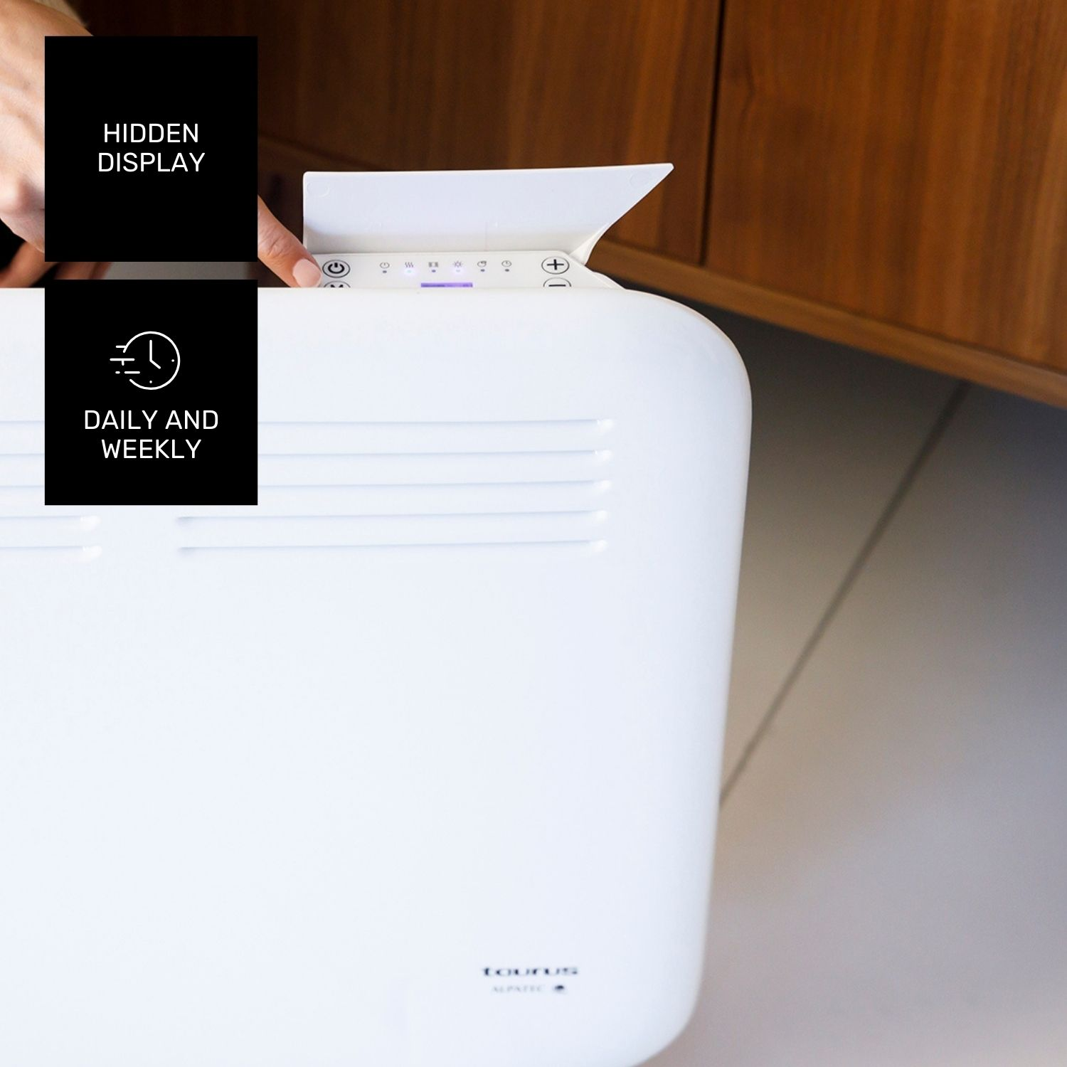 Un calefactor eléctrico blanco con panel de control está siendo tocado. Un armario de madera al fondo.
