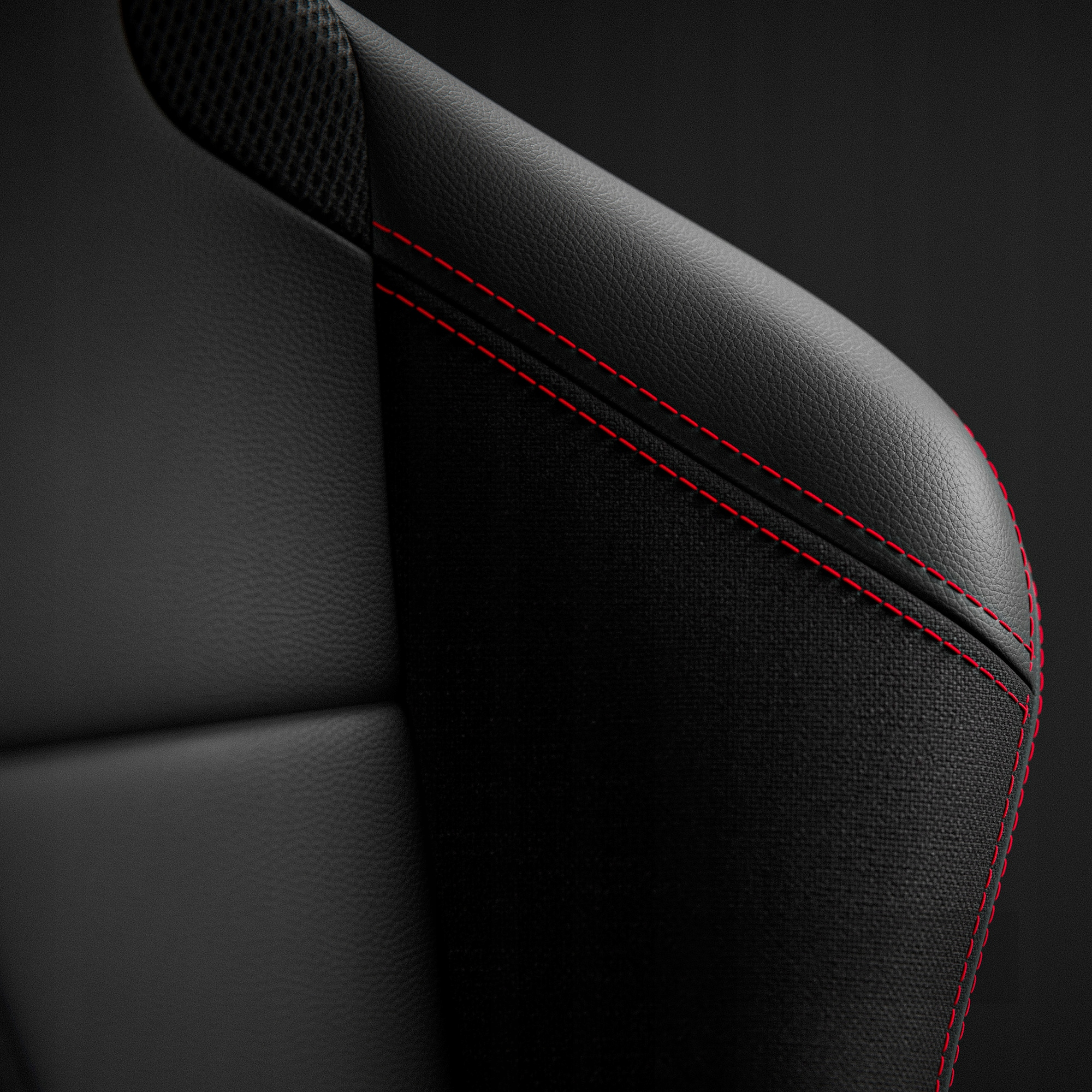 Zbliżenie czarnego skórzanego fotela samochodowego z czerwonymi szwami. Widoczna teksturowana tkanina i gładka skóra.