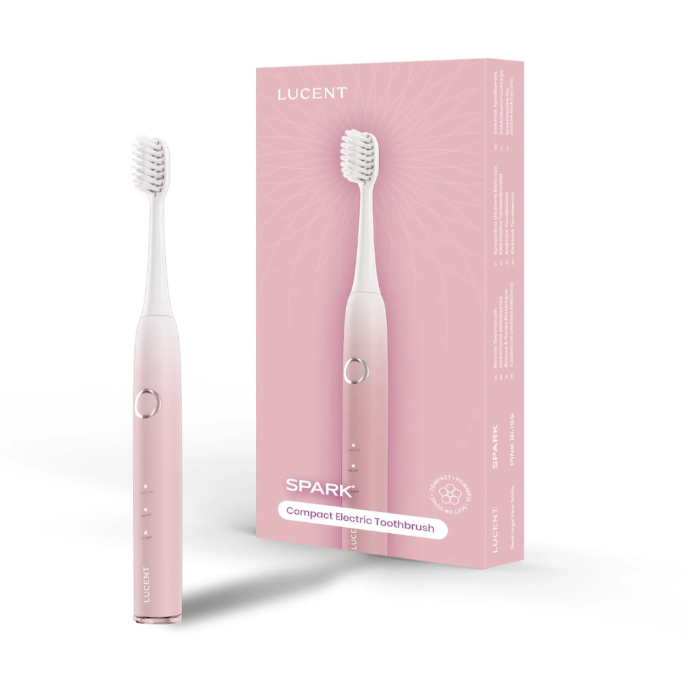 Uno spazzolino elettrico rosa e la sua scatola. Lo spazzolino è a sinistra, la scatola a destra. Entrambi hanno i loghi LUCENT e SPARK.