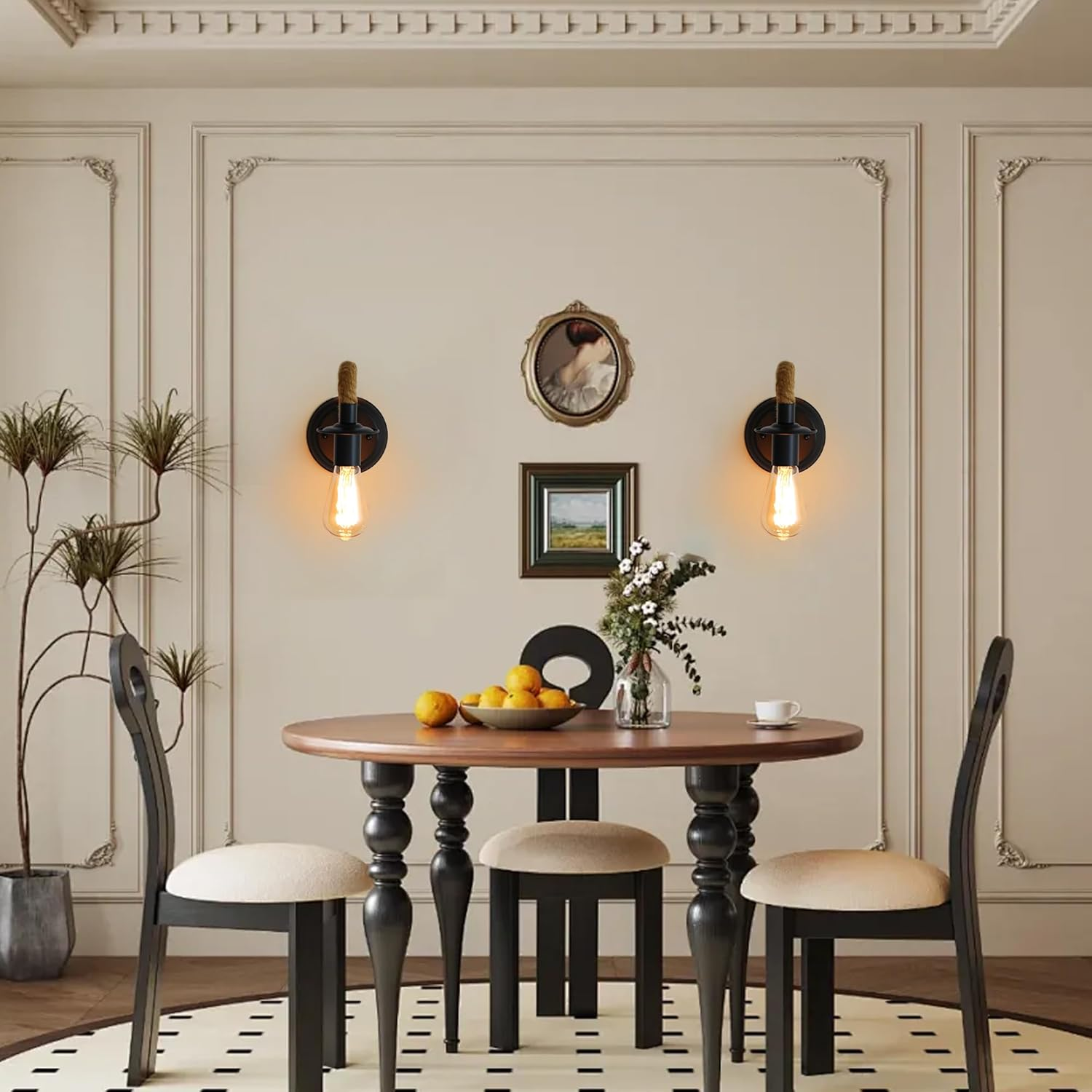 Ein Esszimmer mit rundem Holztisch, Stühlen und Wandleuchten. Orangen und Blumen stehen auf dem Tisch. Auf dem Boden liegt ein Teppich.