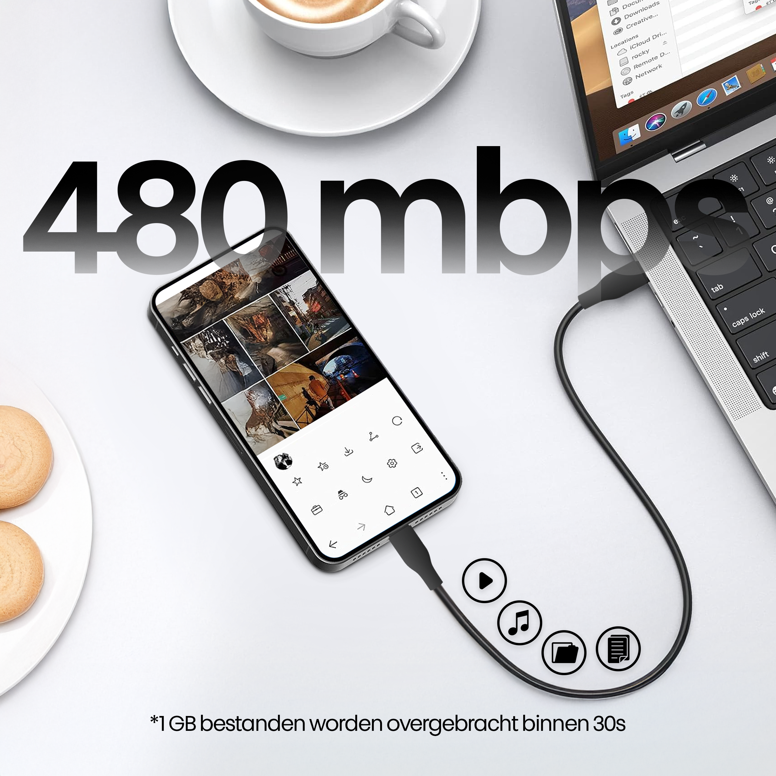Een telefoon die met een kabel is aangesloten op een laptop. Een kopje koffie en koekjes links. De tekst '480 mbps' wordt weergegeven.