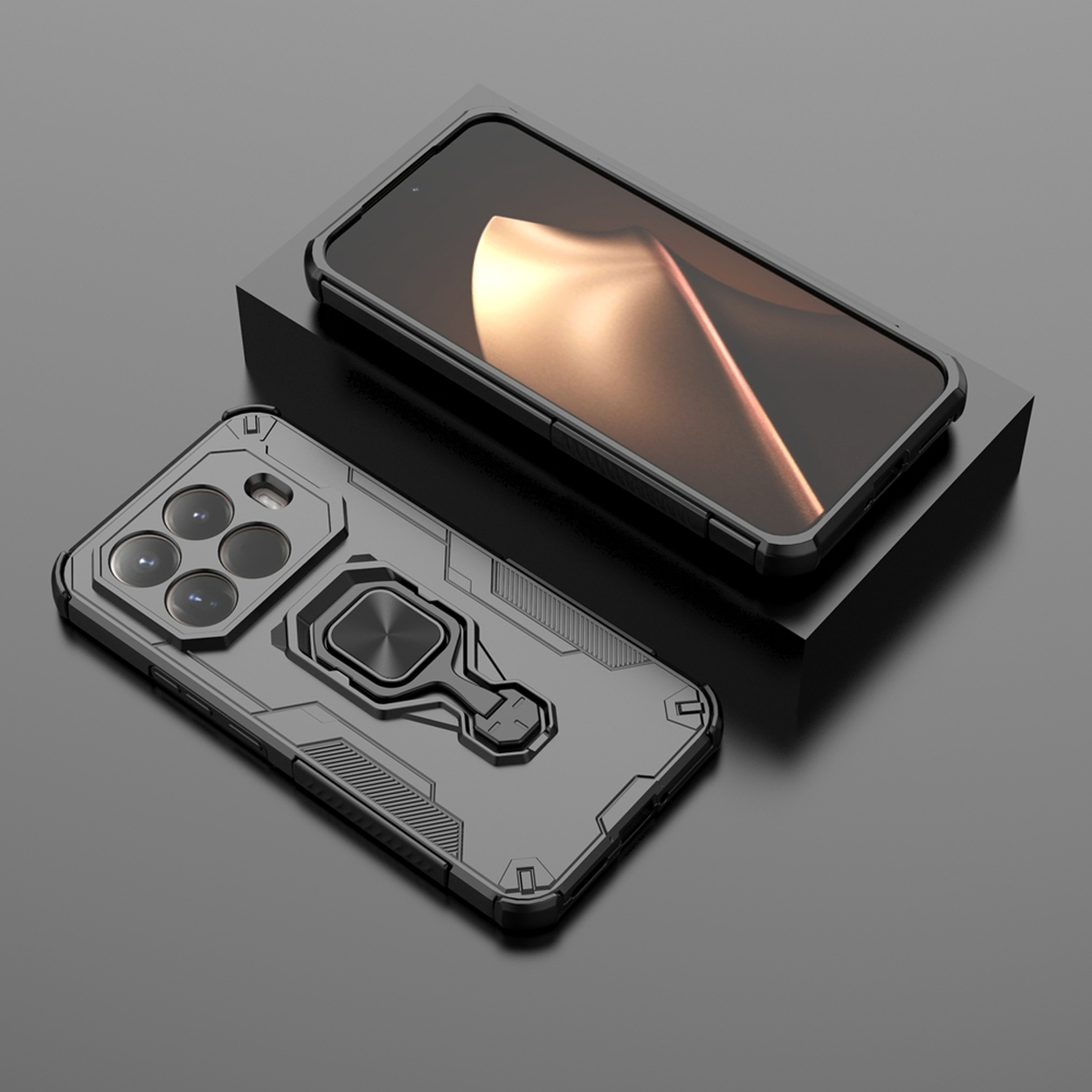 Twee zwarte telefoonhoesjes. Eén met een ringhouder, de andere op een zwart platform. Beide op een reflecterend grijs oppervlak.