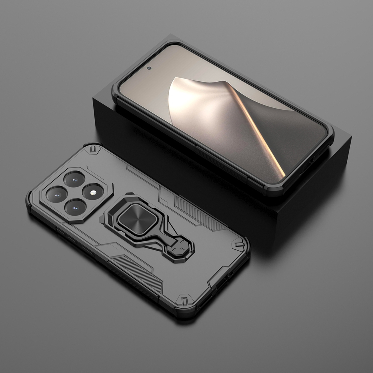 Deux coques de téléphone noires. Une avec écran sur un bloc noir. Une autre avec appareil photo et support d'anneau, sur surface grise.