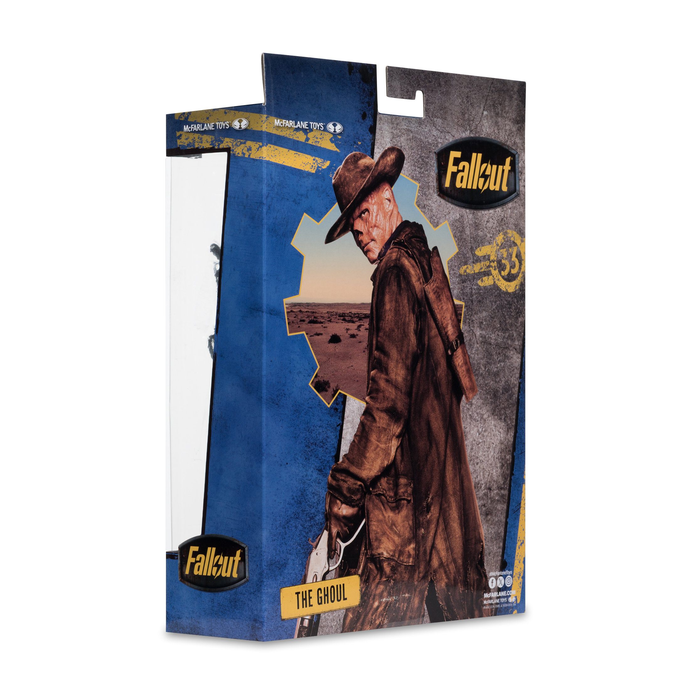 Un action figure di Fallout in una scatola. Il Ghoul, con cappello e cappotto, tiene una pistola. Lo sfondo mostra un deserto.