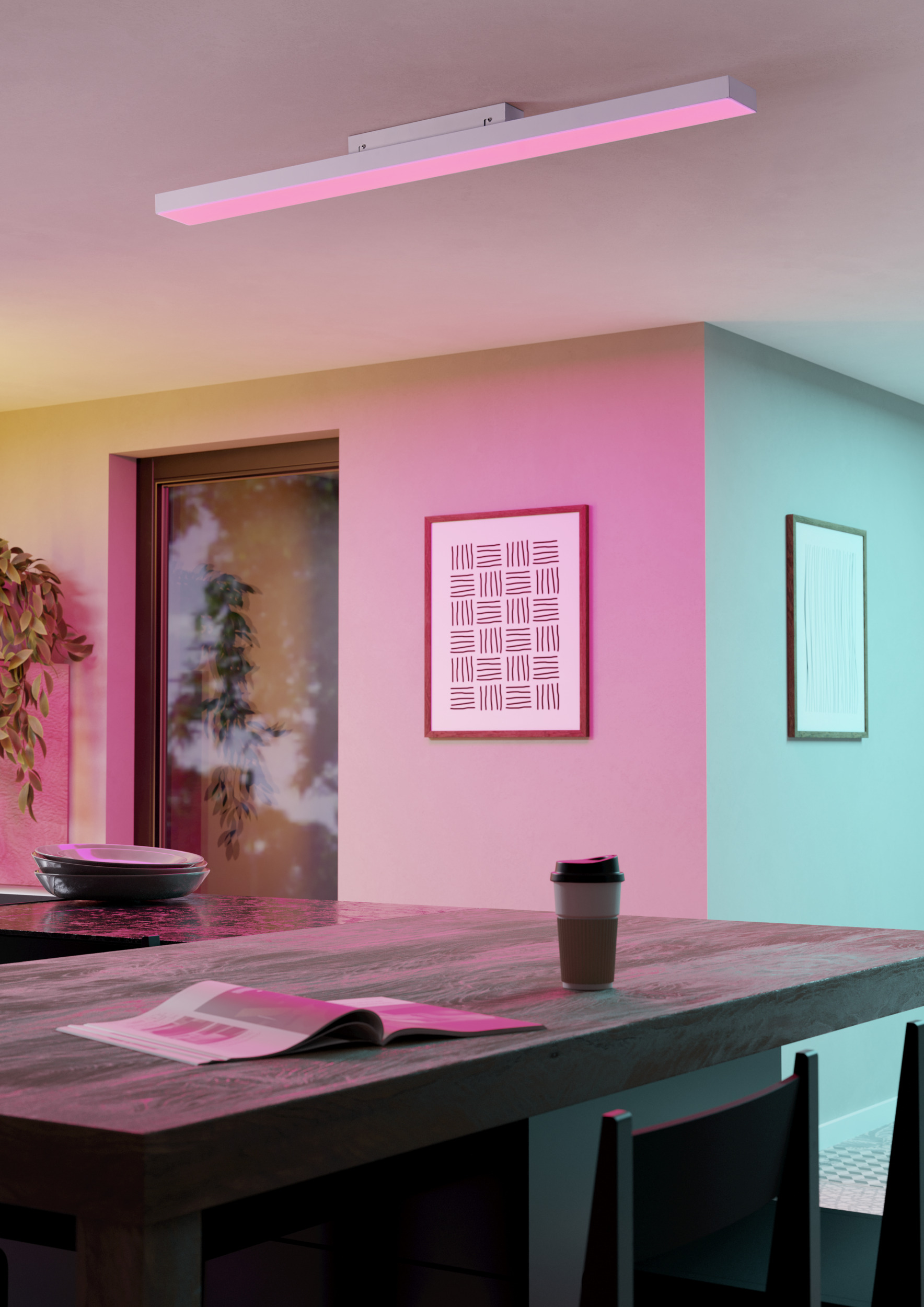 Una cocina moderna con una taza de café, revista y obras de arte en una mesa. Iluminación rosa y azul.