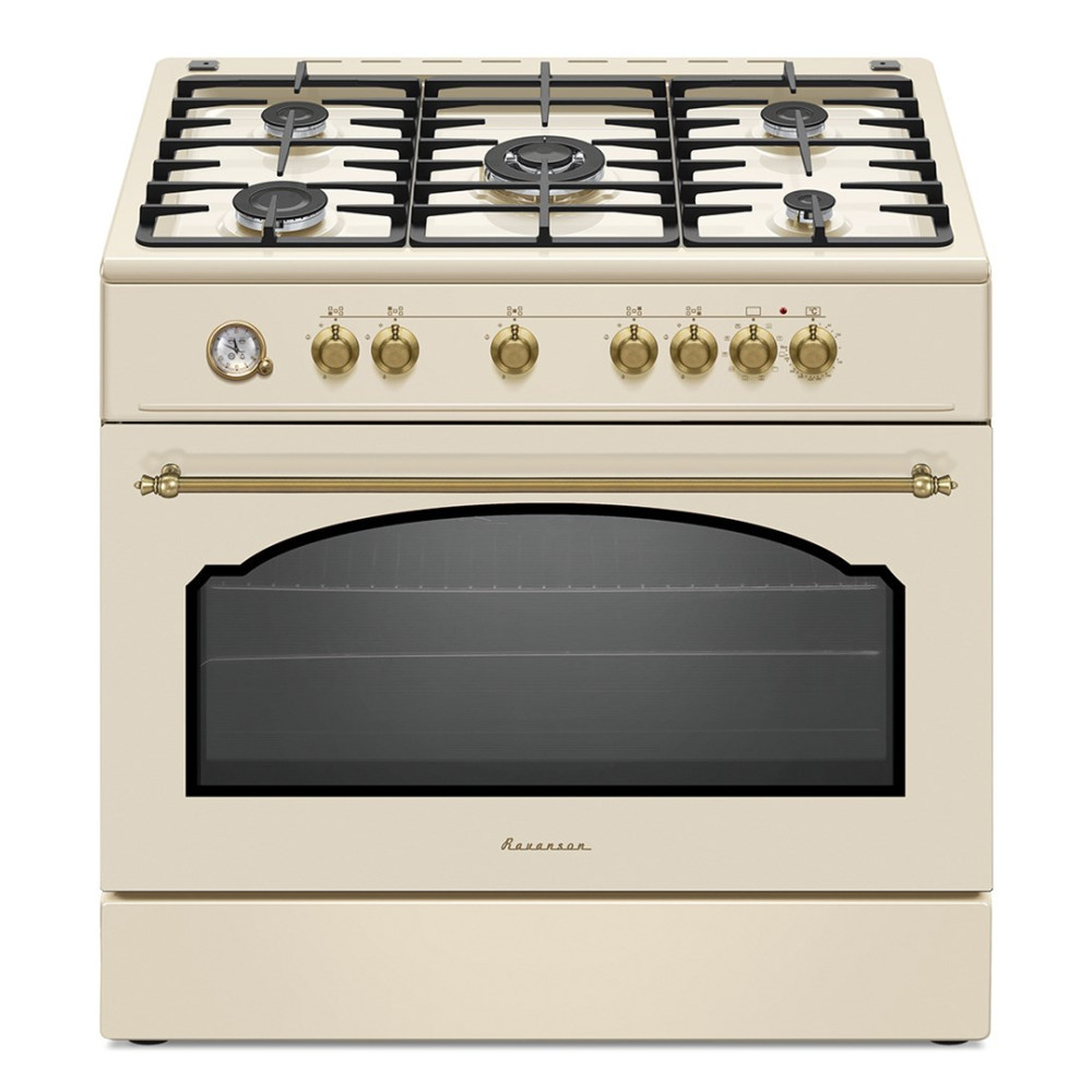 Forno color crema con piano cottura a gas, manopole in ottone e porta del forno. Il forno ha un termometro e il marchio è visibile.