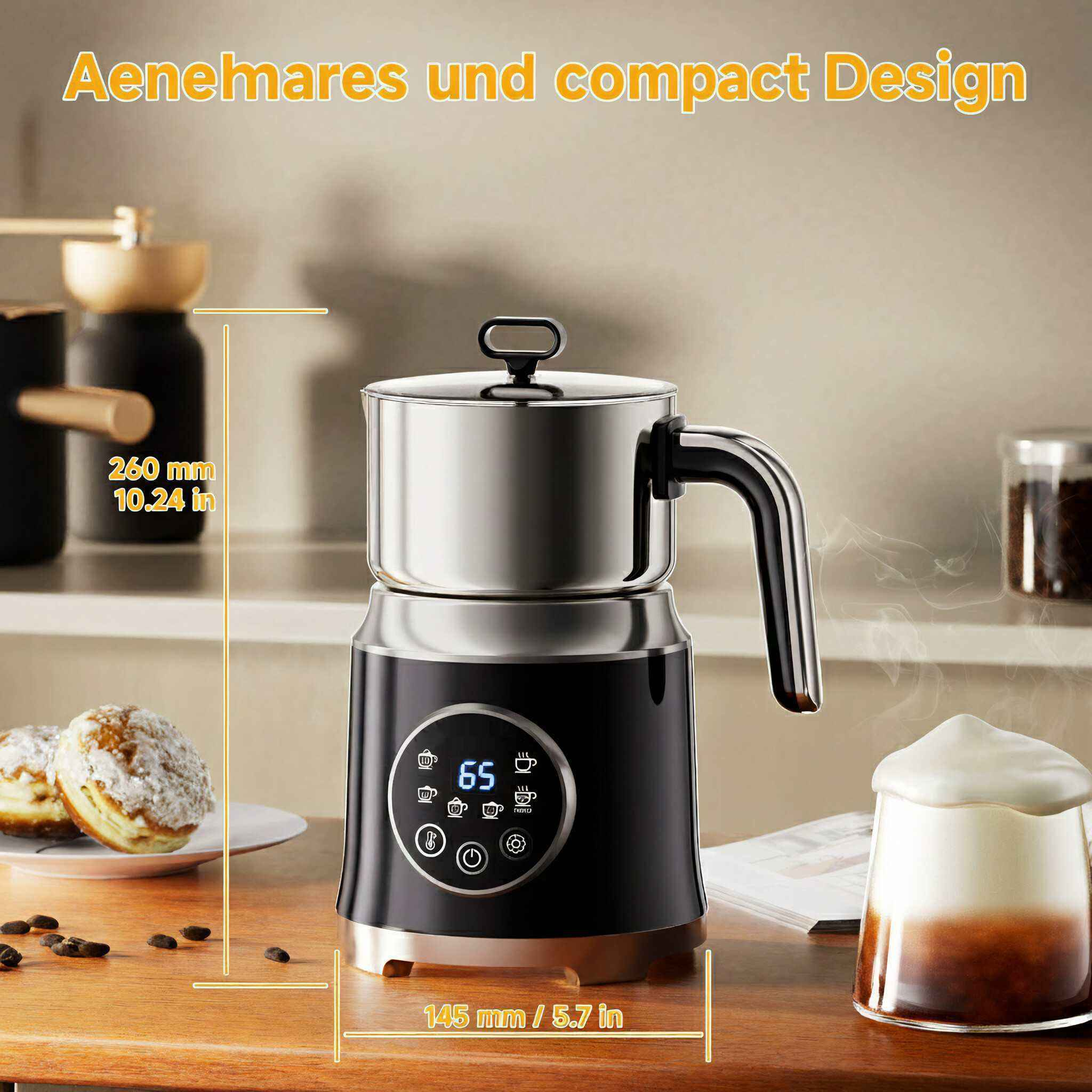 Ein Milchaufschäumer mit schwarzem Sockel und silbernem Oberteil. Ein Glas Kaffee mit Schaum und Donuts sind sichtbar.