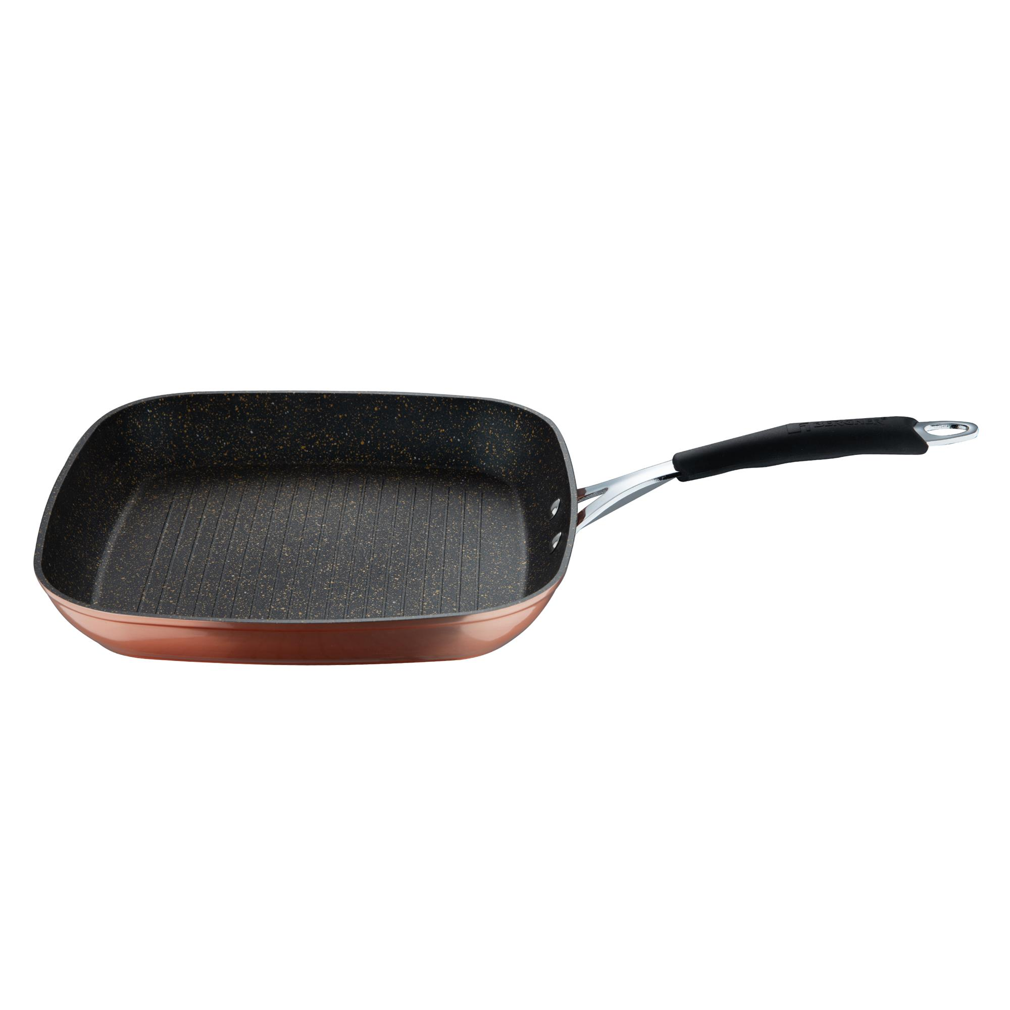 Una sartén cuadrada para asar a la parrilla con interior negro texturizado y exterior color cobre, sobre fondo blanco.