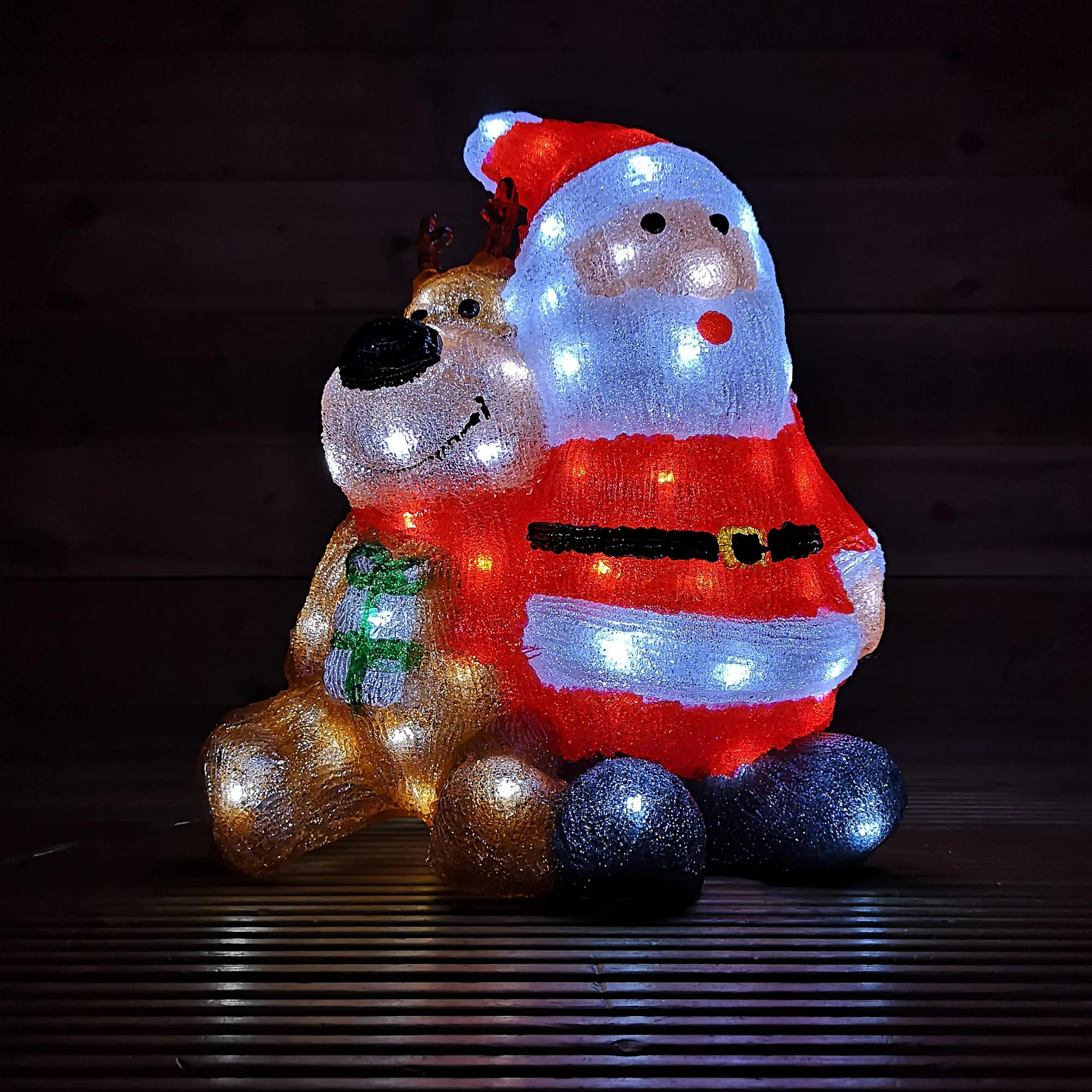 Decoración iluminada de Papá Noel y renos. Papá Noel en rojo y reno en dorado.
