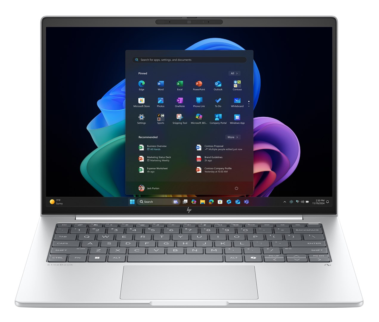 Srebrny laptop wyświetla menu Windows. Widoczna klawiatura i ekran z ikonami i sugestiami aplikacji.