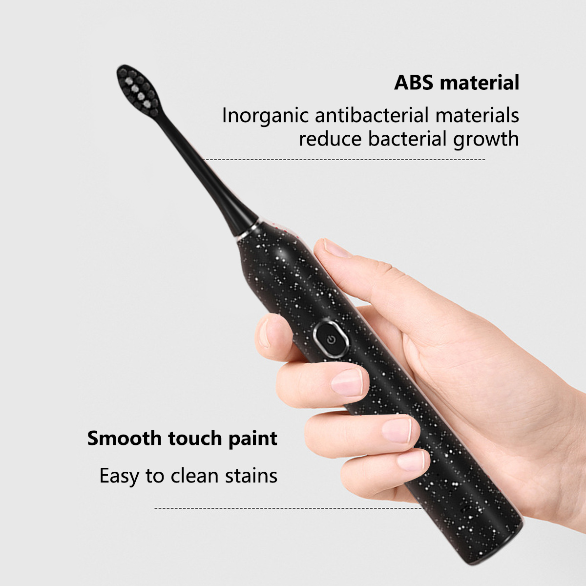 Eine Hand, die eine schwarze elektrische Zahnbürste mit weißen Sprenkeln hält. Text sagt, es ist ABS-Material und leicht zu reinigen.