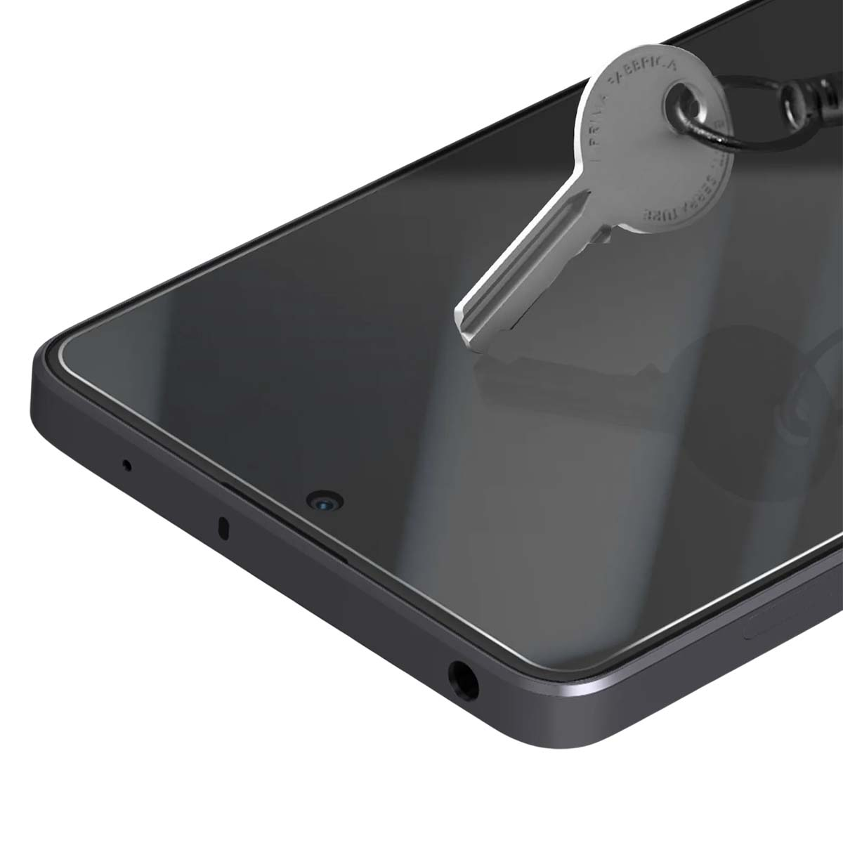 Una chiave poggia sullo schermo scuro di uno smartphone. La chiave è metallica e il telefono ha un bordo grigio scuro.