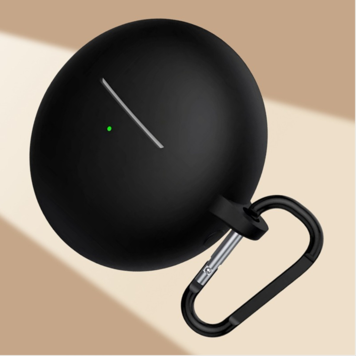 Black, rounded earbud case with a carabiner. A white line and a green dot are visible. Background is light brown.