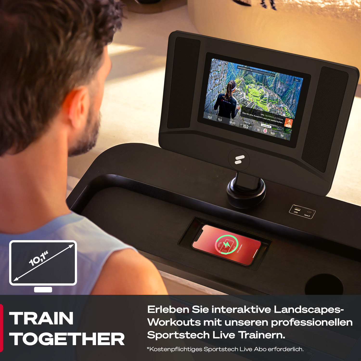 Ein Mann benutzt ein Laufband mit einem Bildschirm, der ein Trainingsvideo zeigt. Ein Telefon wird auf dem Laufband geladen.
