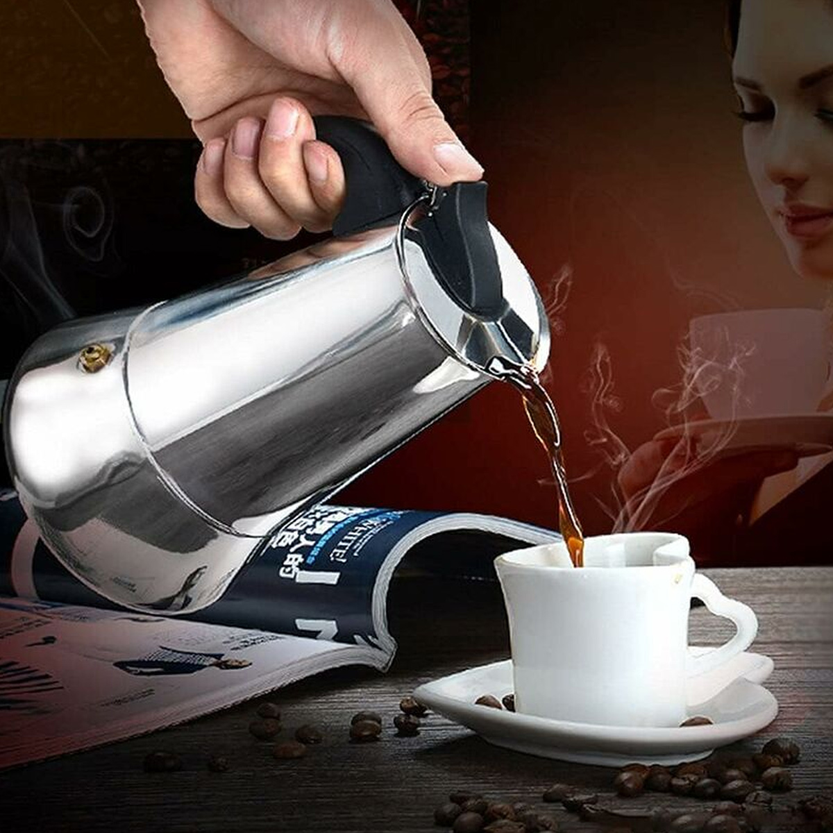 Eine Hand gießt Kaffee aus einem silbernen Topf in eine weiße Tasse. Im Hintergrund ist eine Frau, Dampf steigt auf. Kaffeebohnen und eine Zeitschrift sind vorhanden.