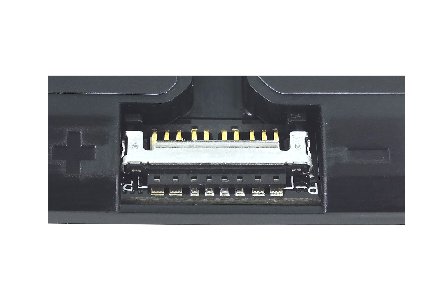 Primo piano di un componente elettronico nero con pin dorati e un connettore argentato. Sfondo bianco, segno più visibile.