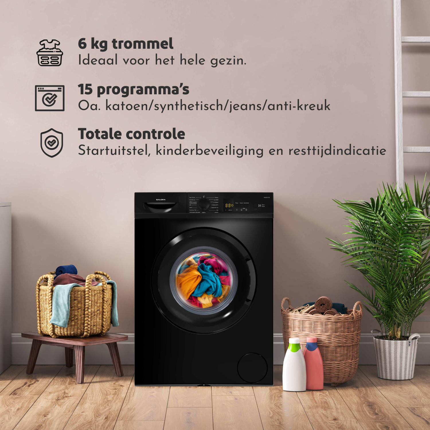 Black washing machine with clothes inside. Baskets with laundry, cleaning products, and a plant are nearby on wooden floor.
