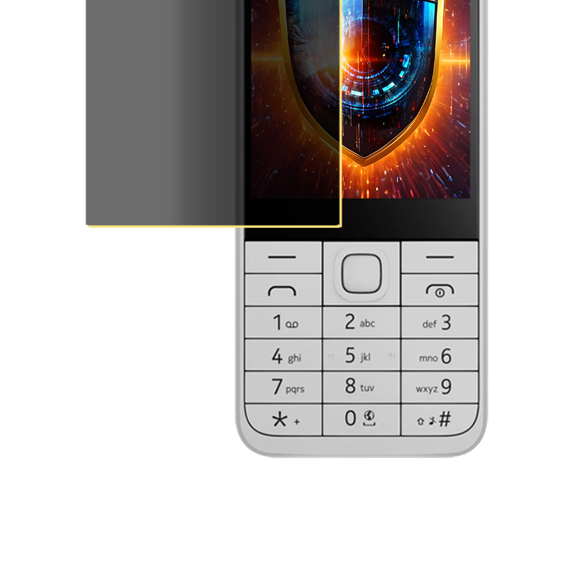 È mostrato un cellulare bianco con tasti numerici. Lo schermo mostra uno scudo. Una protezione per lo schermo scura lo copre.