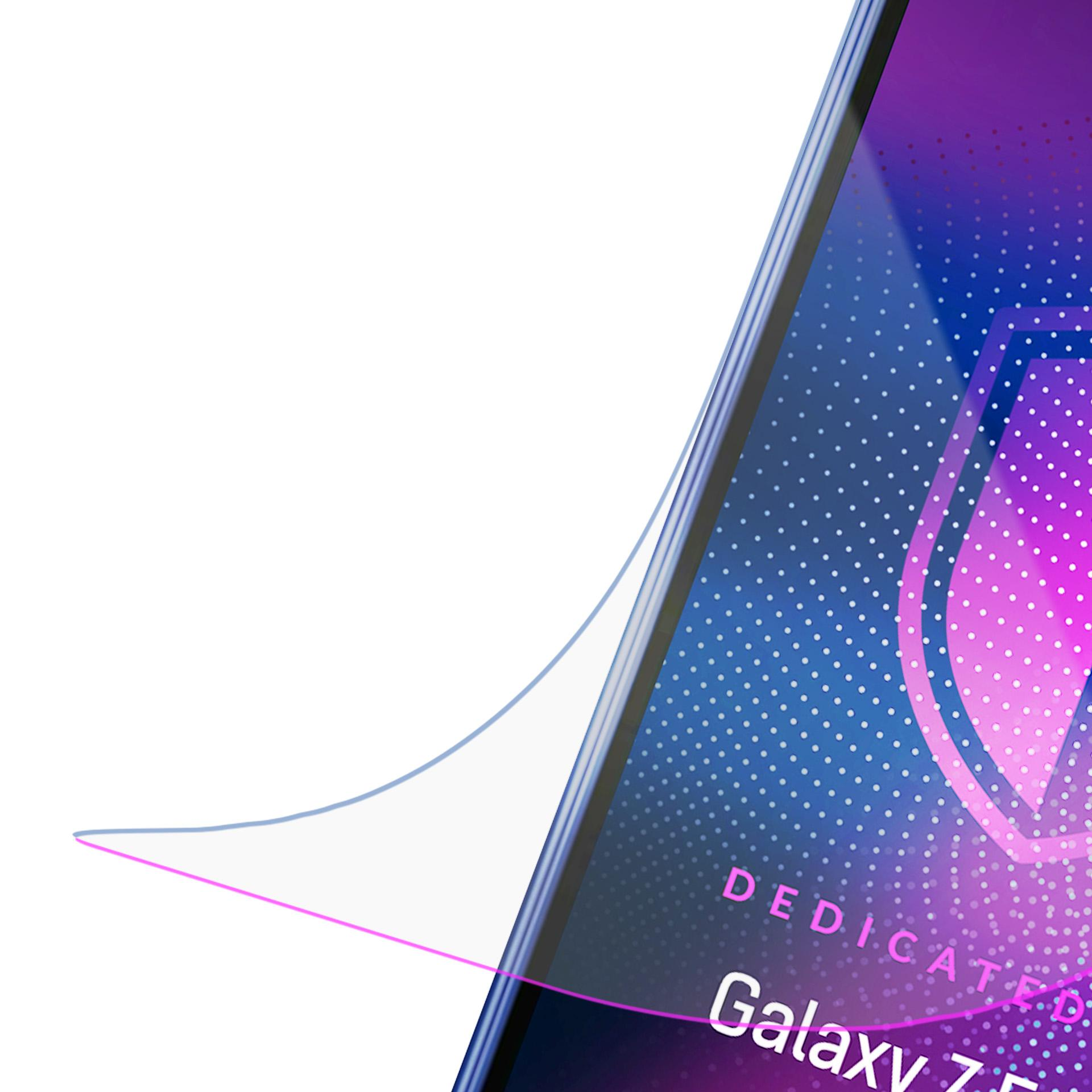 Un angolo dello schermo di un telefono con uno sfondo sfumato blu e viola con punti bianchi e le parole Dedicated Galaxy Z.